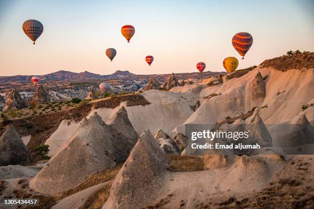 soar high in hot air balloons of cappadocia, turkey - blowing balloon stock pictures, royalty-free photos & images