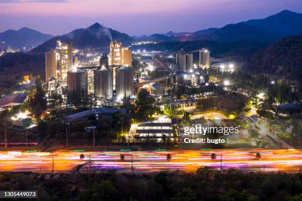 a cement plant manufacturing concrete at night - cement factory stock pictures, royalty-free photos & images