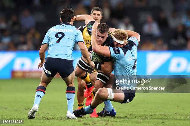 Fergus Lee-Warner of the Force is tackled during the round three Super RugbyAU match between the Waratahs and the Western Force at Bankwest Stadium,...