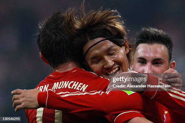 Takashi Usami of Muenchen celebrates scoring the 6th goal with his team mates Ivica Olic and Diego Contento during the DFB Cup second round match...