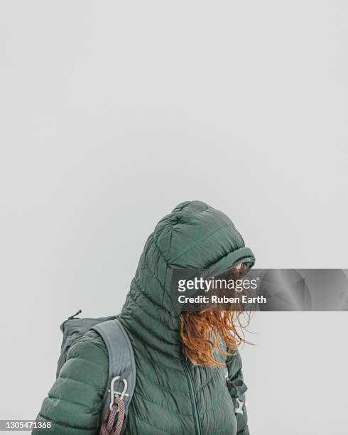 woman dressed in mountain clothes on an foggy, windy and snowy landscape - winter bride stock pictures, royalty-free photos & images