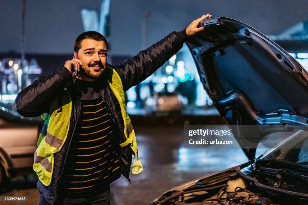 Man calling for help by the broken car