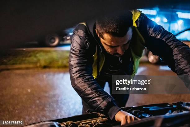 man trying to repair car on road - roadside challenge stock pictures, royalty-free photos & images