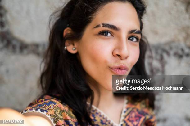 selfie of a young latino woman, point of view from her cell phone - mexico city, mexico - puckering stock pictures, royalty-free photos & images