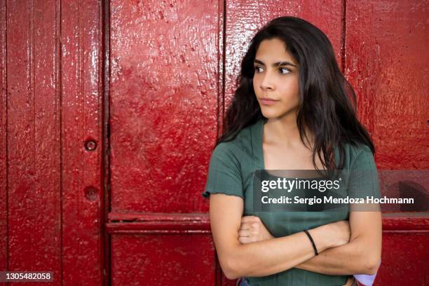 young latino woman, arms crossed and looking impatient in mexico city - beautiful mexican girls stock pictures, royalty-free photos & images