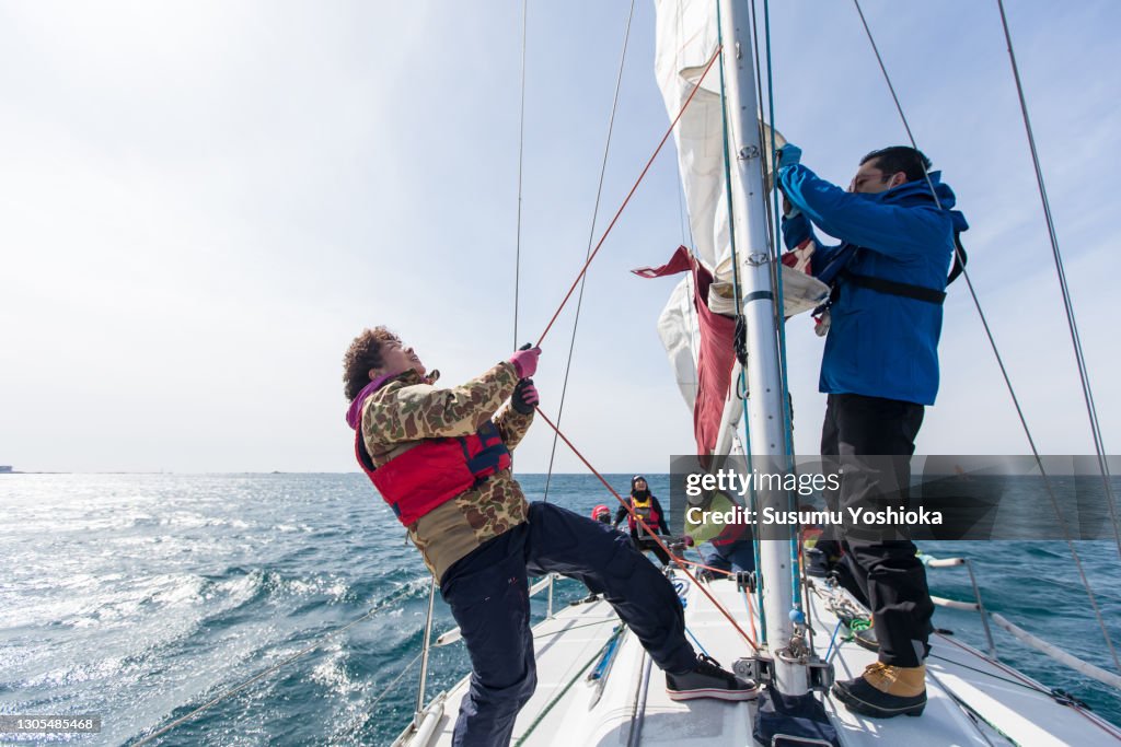 A group of middle-aged and older adults enjoying a winter weekend sailing in the ocean.