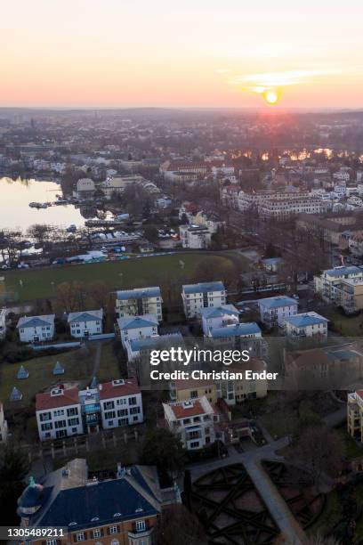 In this aerial view from a drone houses and residential buildings stand next to the Glienicke Bridge at sunset during the novel coronavirus pandemic...