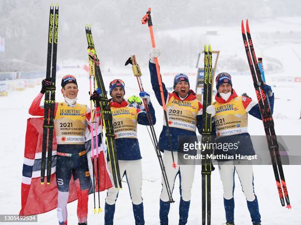 Johannes Hoesflot Klaebo, Hans Christer Holund, Emil Iversen and Paal Golberg of Norway celebrate first place during the Men's Cross Country 4x10 km...