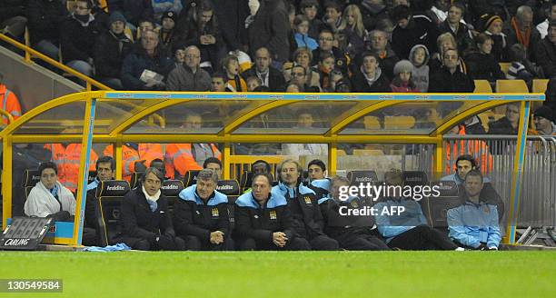 Manchester City manager Roberto Mancini looks on next to his assistants Brian Kidd and David Platt during their League Cup fourth round football...