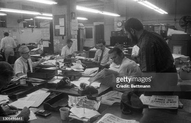 The men in the newsroom of the New York Post are busy at work even though all of their brethen on the city's other major papers had a day off. Not a...