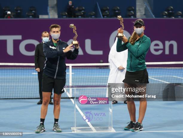 Demi Schuurs of The Netherlands and Nicole Melichar of The United States pose with their trophies after winning their doubles Final match against...