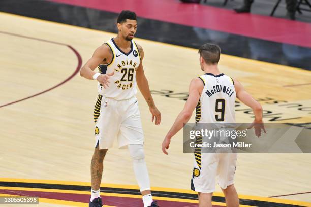 Jeremy Lamb celebrates with T.J. McConnell of the Indiana Pacers during the fourth quarter against the Cleveland Cavaliers at Rocket Mortgage...