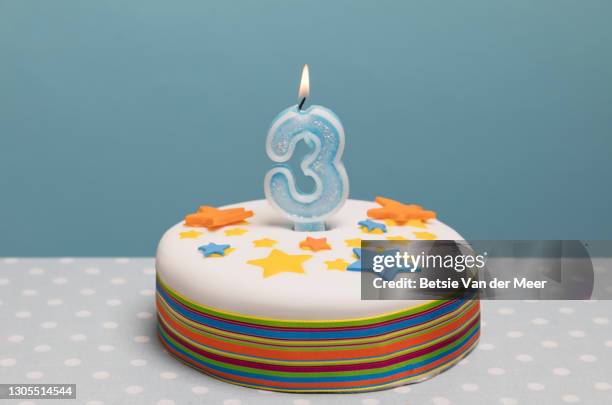 birthday cake with a number 3 candle burning on top. - birthday candle stock pictures, royalty-free photos & images