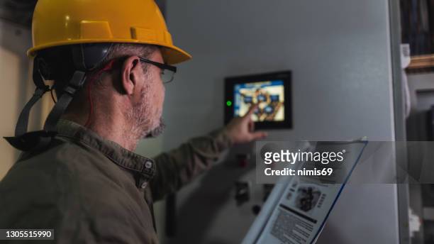 engineer working on computer to maintain heating and cooling sistems - energy saving stock pictures, royalty-free photos & images