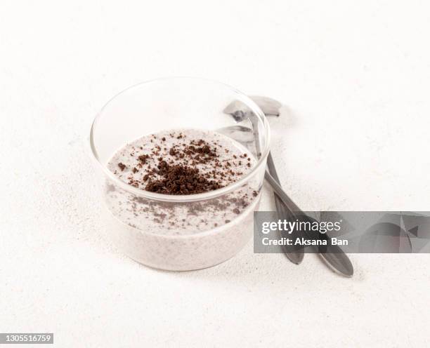 italian dessert panna cotta with chocolate chip cookie crumbs in a glass on a white background - panna cotta stock pictures, royalty-free photos & images