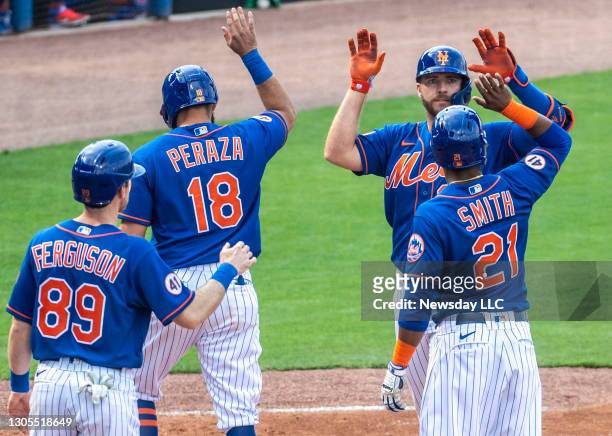 New York Mets' Pete Alonso celebrates with his teammates Drew Ferguson , Jose Peraza and Dominic Smith after hitting a grand slam in the fifth inning...