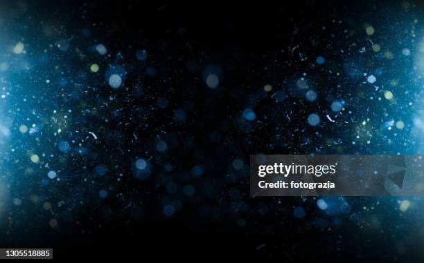 defocused particles background - blue confetti stockfoto's en -beelden