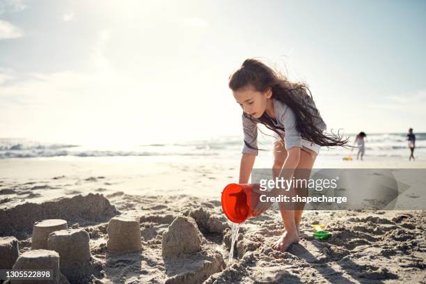 bring your beach toys along and have some fun! - sandcastle stock pictures, royalty-free photos & images