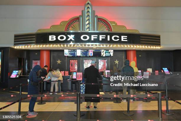 Moviegoers line up at the AMC Loews Lincoln Square box office on March 05, 2021 in New York City. AMC Theatres reopened its New York area locations...