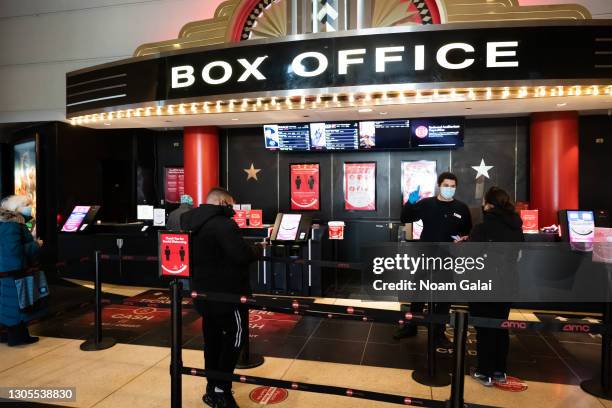 Moviegoers line up at the AMC Lincoln Square 13 box office on March 05, 2021 in New York City. AMC Theatres reopened its New York area locations...