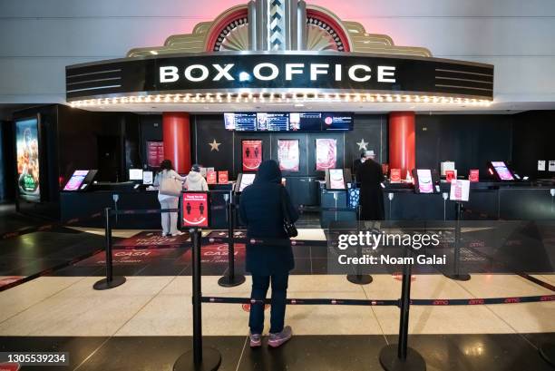 Moviegoers line up at the AMC Lincoln Square 13 box office on March 05, 2021 in New York City. AMC Theatres reopened its New York area locations...