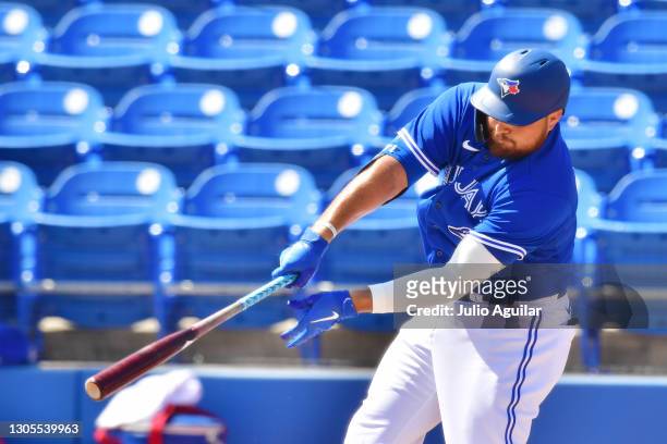 Rowdy Tellez of the Toronto Blue Jays hits a double in the first inning of a spring training game against the Baltimore Orioles on March 05, 2021 at...