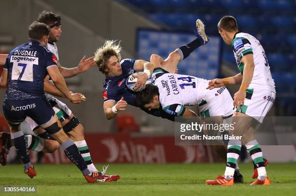 Sale Sharks scrum half Faf de Klerk is upended by Newcastle Falcons wing Mateo Carreras during the Gallagher Premiership Rugby match between Sale and...