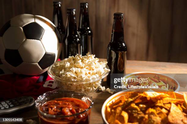 watching the soccer game with snacks, drinks. - beer nuts stock pictures, royalty-free photos & images