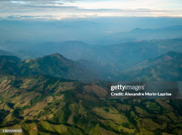 green hills full of pasture for cattle and crop fields in the mountains in bogota, colombia - hill range stock pictures, royalty-free photos & images