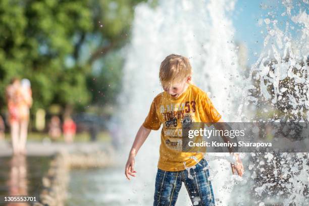 summer in the city - little boy playing with fountain - stock photo - perm russian city stock pictures, royalty-free photos & images