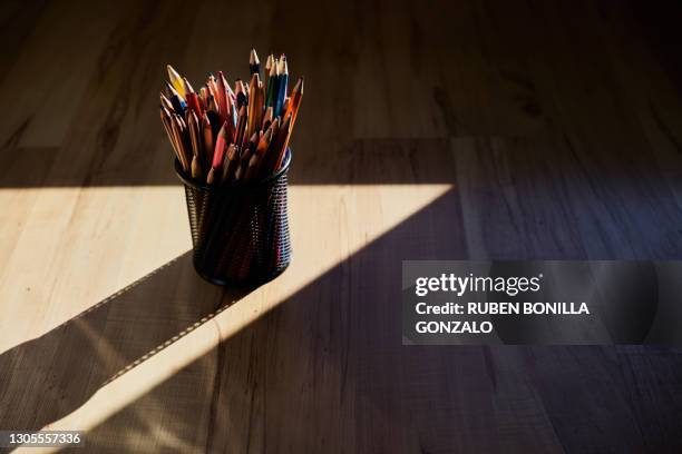 color pencils  isolated in metallic can on wooden background - colorful stationary stock pictures, royalty-free photos & images