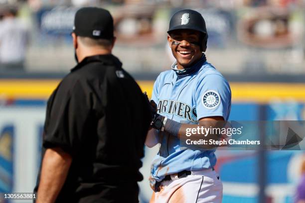 Julio Rodriguez of the Seattle Mariners reacts after stealing second base against the Colorado Rockies in the fifth inning during an MLB spring...