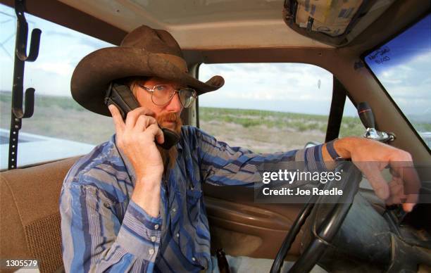 Bruce Seale a modern day cowboy stays in touch via a cell phone as he works on a ranch, July 22 in El Paso, Texas. The Cellular Telecommunications...