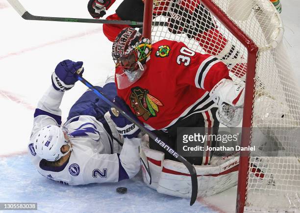 Luke Schenn of the Tampa Bay Lightning collides with Malcolm Subban of the Chicago Blackhawks after trying to shoot in the third period at the United...