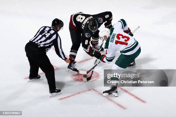 Nick Bonino of the Minnesota Wild faces off against Nick Schmaltz of the Arizona Coyotes during the third period of the NHL game at Gila River Arena...