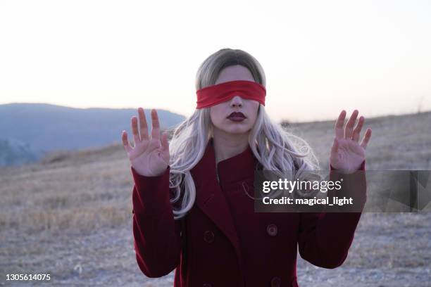 young woman wearing red blindfold - blind fold stock pictures, royalty-free photos & images