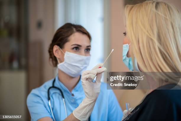 home visit. taking nasal swab. covid-19 vaccination. - serbia covid stock pictures, royalty-free photos & images