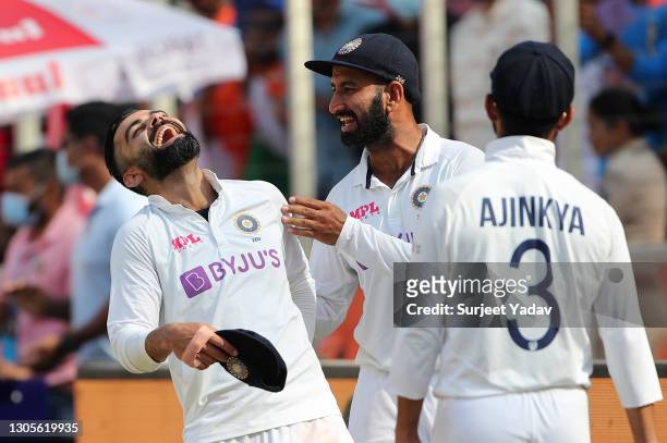 Virat Kohli, Cheteshwar Pujara and Ajinkya Rahane of India celebrate victory after Day Three of the 4th Test Match between India and England at the...