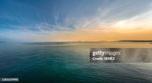 scenic view of sea against clear sky during sunset - breit stock-fotos und bilder