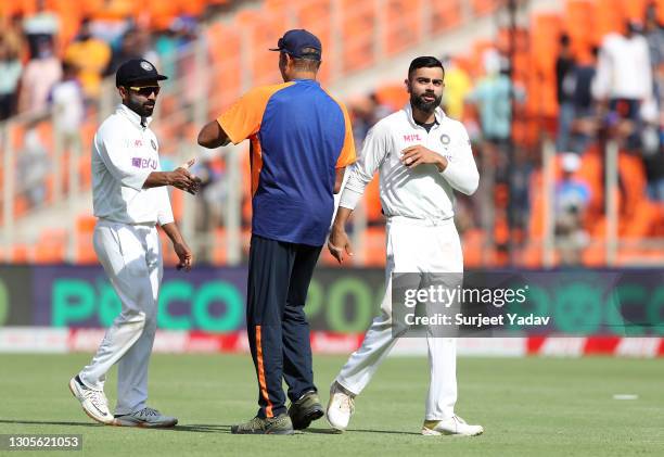 Ajinkya Rahane and Virat Kohli of India shake hands with India Head Coach, Ravi Shastri after victory on Day Three of the 4th Test Match between...