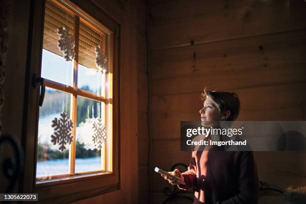 little boy opening the roller shutter in the morning - roller shutter stock pictures, royalty-free photos & images