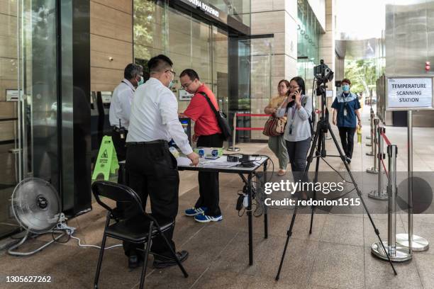 dorscon level raised to orange in singapore - singapore city people stock pictures, royalty-free photos & images