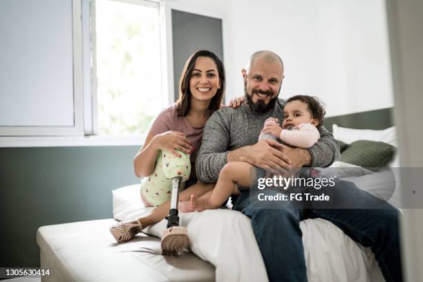 portrait of a family at home (including a disability mother) - prosthetic equipment stock pictures, royalty-free photos & images