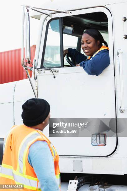 female truck driver, dock worker conversing - leanincollection stock pictures, royalty-free photos & images