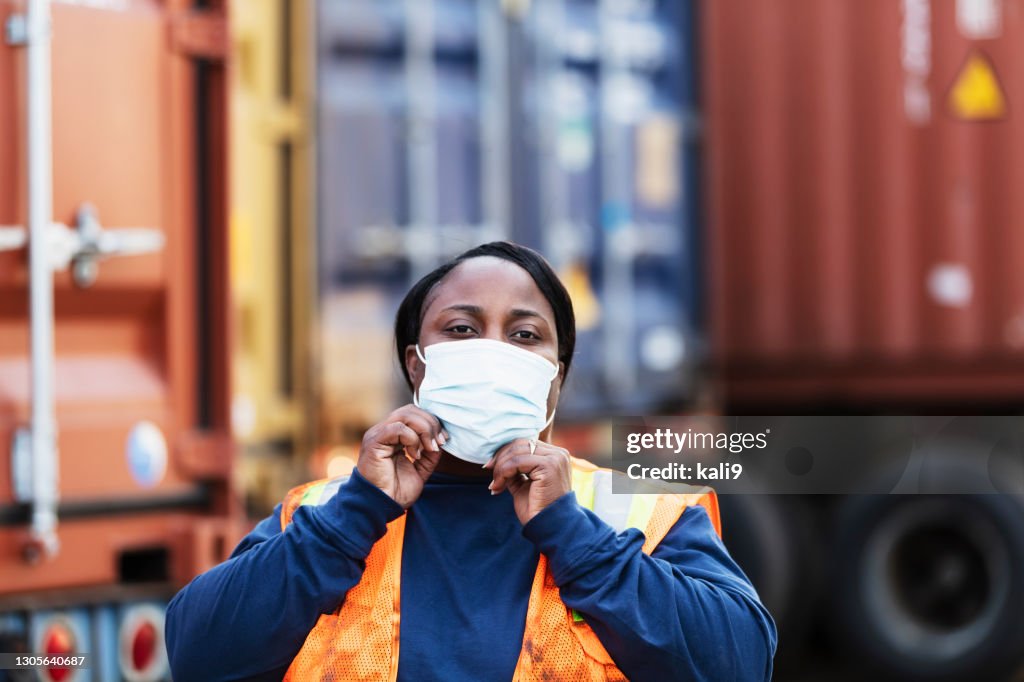 Cargo Container Maskcot Worker At Shipping Port With Cargo Containers Face Mask High-Res Stock ...