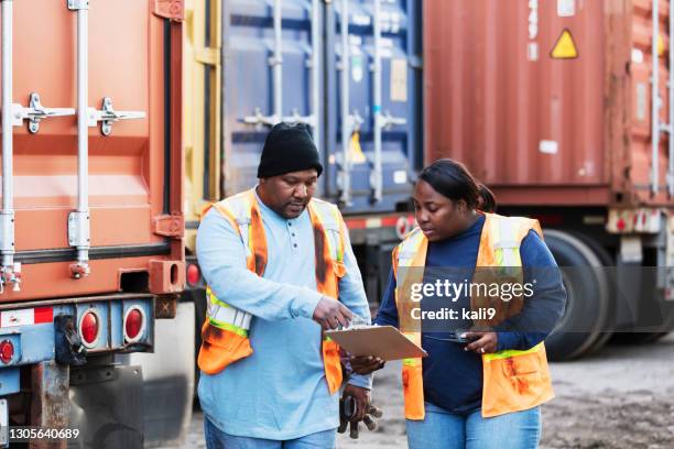 two workers at freight company talking,, with clipboard - fleet manager stock pictures, royalty-free photos & images