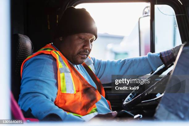 african-american man driving a semi-truck - african lorry stock pictures, royalty-free photos & images