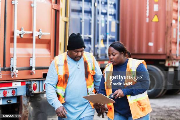 two workers at freight company talking,, with clipboard - fleet manager stock pictures, royalty-free photos & images