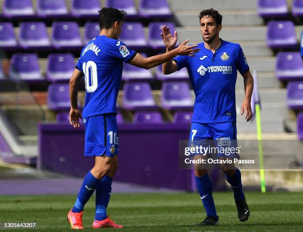 Jaime Mata of Getafe CF celebrates with teammate Enes Uenal after scoring his team's first goal during the La Liga Santander match between Real...