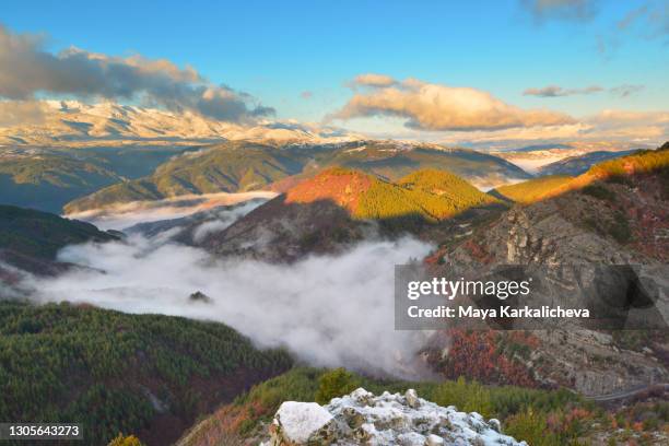 idyllic mountain landscape with view of valley full with fog and snowcapped peaks in the background - pirin mountains stock pictures, royalty-free photos & images